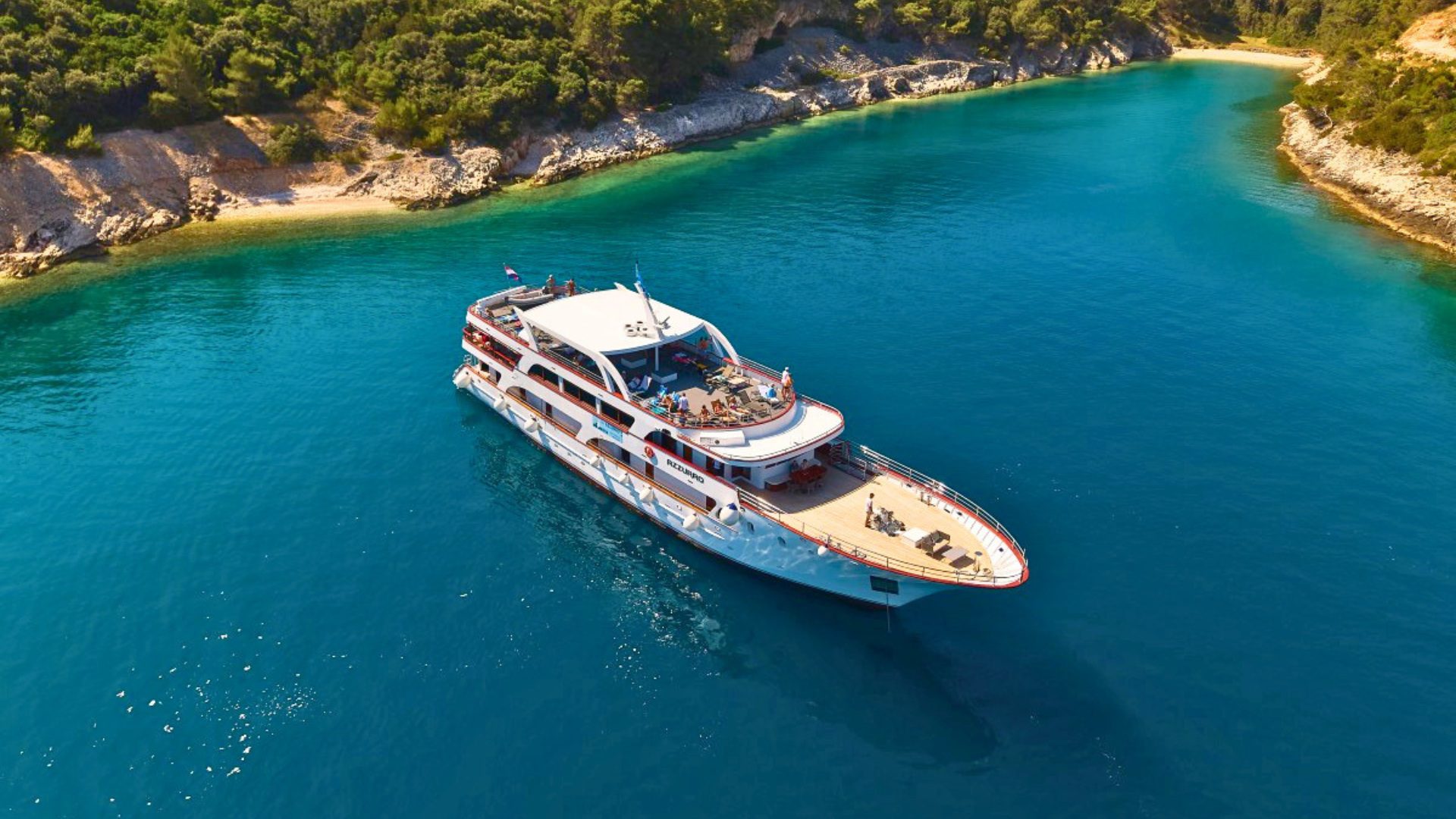 MS Azzurro At Anchor in a blue water bay