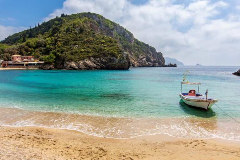 Boat on clear blue water in a bay on Corfu, Greece