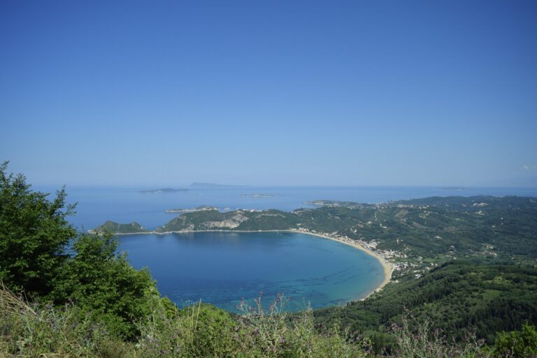 Sweeping bay and beach seen from a forested headland on Corfu, Greece